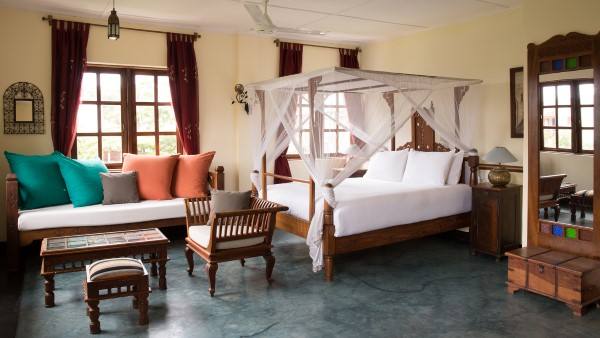 A deluxe room with carved daybed