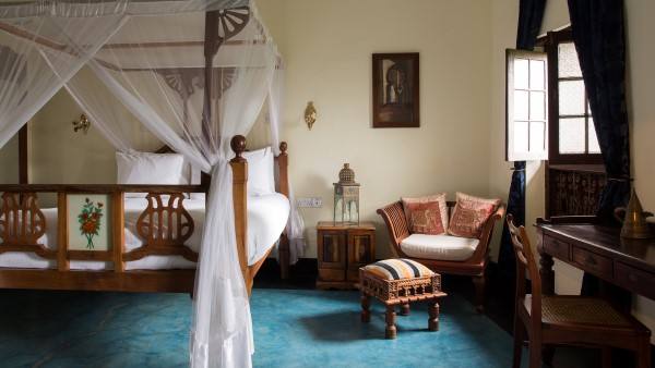 Deluxe Room with hand-carved wooden furnishings